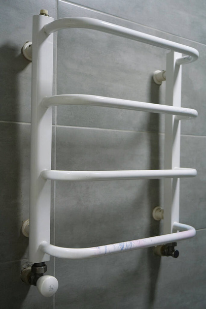 Heated towel rail in bathroom - Fotoğraf, Görsel