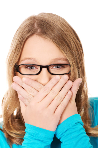 Teenager covering her mouth - Φωτογραφία, εικόνα