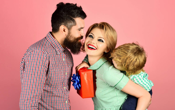 Fathers day celebration. Cute little boy with mother congratulating father. Gift box for birthday. Happy family celebrating holiday together. Cute son and mother greeting dad with present box - Photo, Image