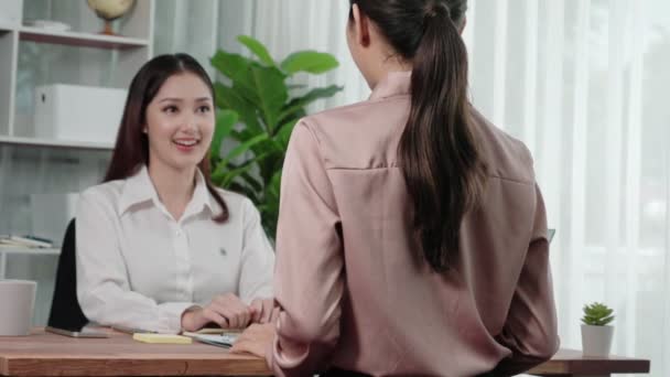 Young and enthusiastic candidate interview with professional HR manager in the office. Employer reviewing applicants resume in preparation for employment interview. - Footage, Video