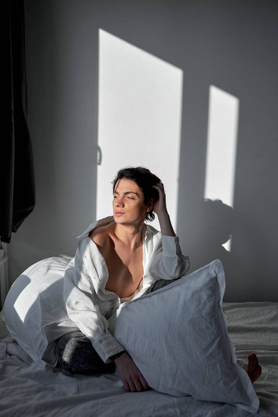 young elegant sexy shirtless man with slim perfect body wakening in the morning, full length shot. - Foto, Bild
