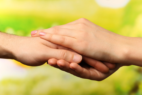 Male and female hands on bright background - Photo, Image