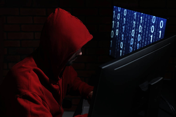 Hacker working with computers in dark room. Cyber attack - 写真・画像