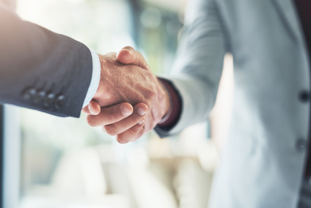 Merging for success. two unrecognizable businessmen shaking hands after making a deal in the office - Fotografie, Obrázek