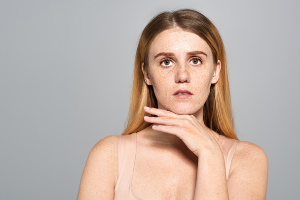 Portrait of freckled woman looking at camera isolated on grey  - Photo, Image