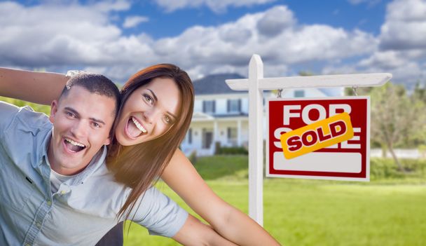 Military Couple In Front of Home with Sold Sign - Photo, Image