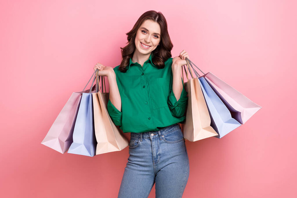 Photo of charming pretty lady dressed green blouse smiling rising bargains isolated pink color background. - Фото, изображение