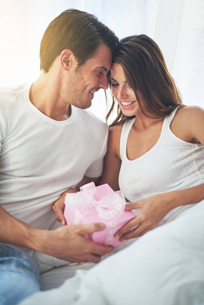 Man giving woman gift, love and happy with partnership, relationship and celebration on Valentines day date. Couple smile with present, luxury and commitment, gratitude and celebrate holiday. - Photo, image