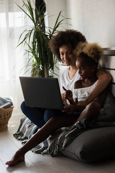 african american mother and daughter using laptop - Photo, Image