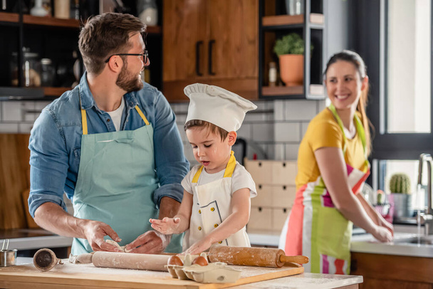 family cooking together, mother, father and son - Fotoğraf, Görsel