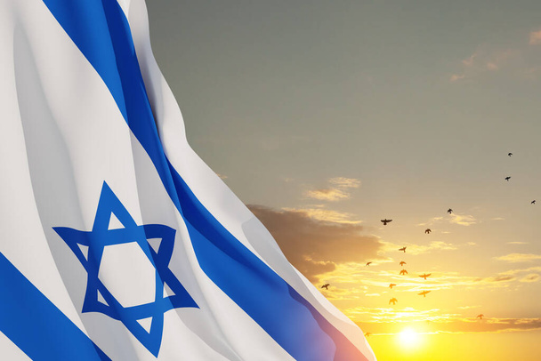 Israel flag with a star of David over cloudy sky background with flying birds on sunset. Patriotic concept about Israel with national state symbols. Banner with place for text. - Foto, Bild