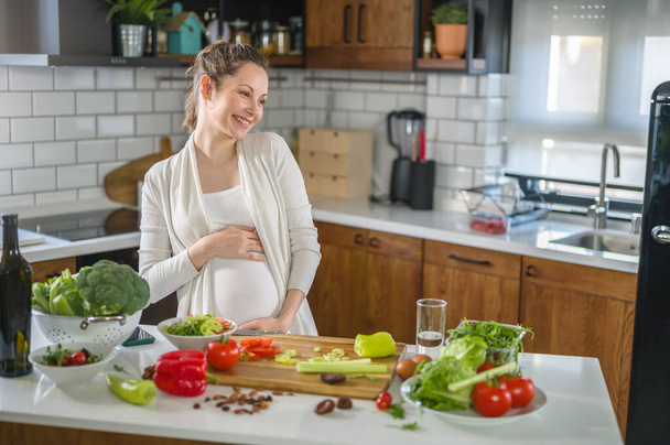 beautiful pregnant woman on kitchen - Фото, изображение