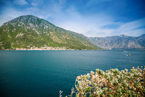 View of historic town of Perast at famous Bay of Kotor on a beautiful sunny day, Montenegro - Fotó, kép