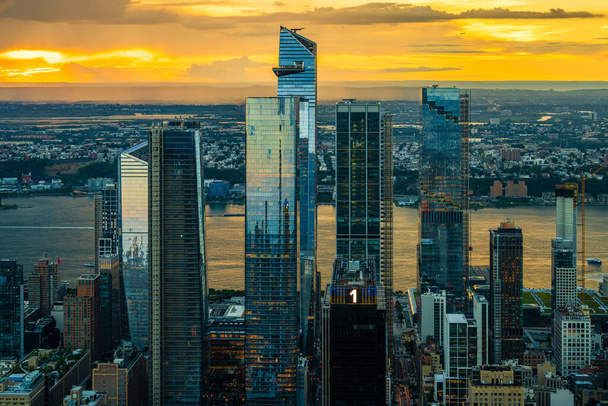 An orange sunset over the Hudson Yards in New York City. - Photo, Image