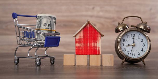 House model with shopping cart. Buying house - Photo, Image