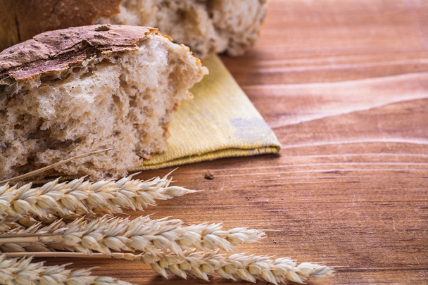 Slice of bread with wheat ears - Фото, изображение