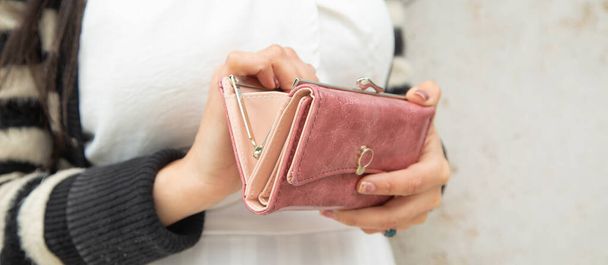 Young woman holding empty wallet. No Money - Photo, image