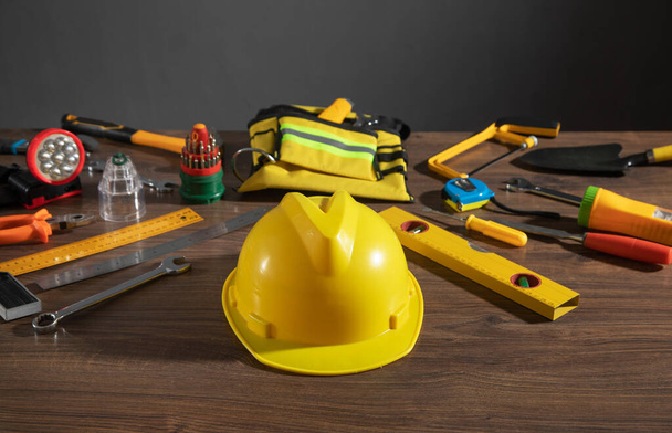 Work tools with helmet on wooden background. - Photo, Image