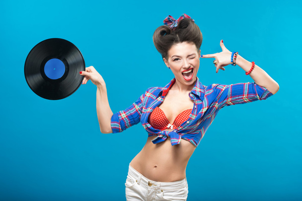 The vintage photo of girl holding vinyl record. - Foto, imagen