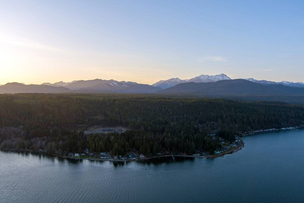 Aerial view of the Puget Sound and the Olympic Mountains at sunset in Potlatch, Washington - Photo, Image