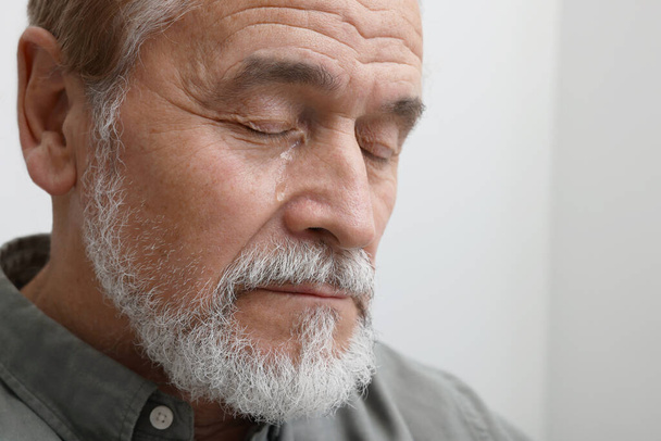 Upset senior man crying indoors, closeup. Loneliness concept - Fotoğraf, Görsel