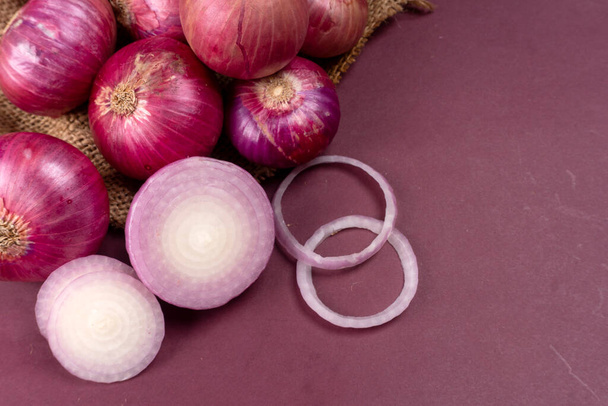 fresh red onions with sackcloth, close up view - Photo, Image