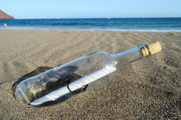 Message dans une bouteille sur la plage de sable - Photo, image