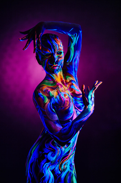 Fantasy woman with body art glowing in neon light - Фото, зображення