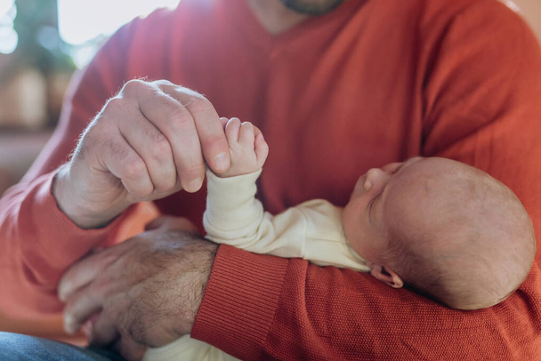 Close-up of father holding his little new born baby. - 写真・画像