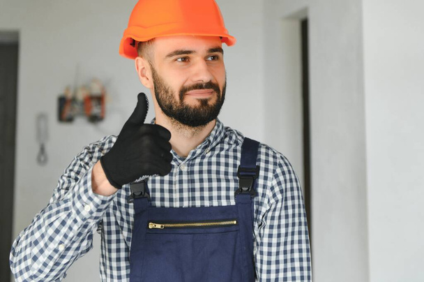 Builder handyman with construction tools. House renovation background - Foto, Bild