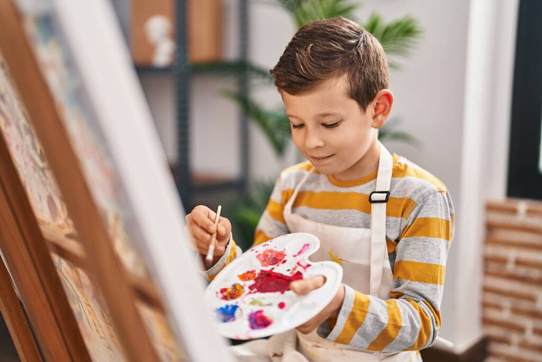 Niño rubio sonriendo dibujo seguro en el estudio de arte - Foto, Imagen