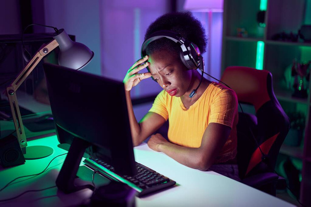African american woman streamer stressed using computer at gaming room - Fotó, kép