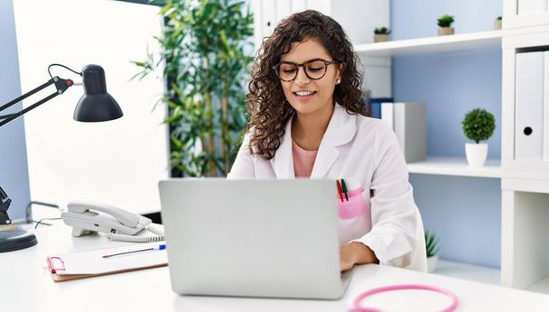 Young latin woman wearing doctor uniform working at clinic - Photo, Image