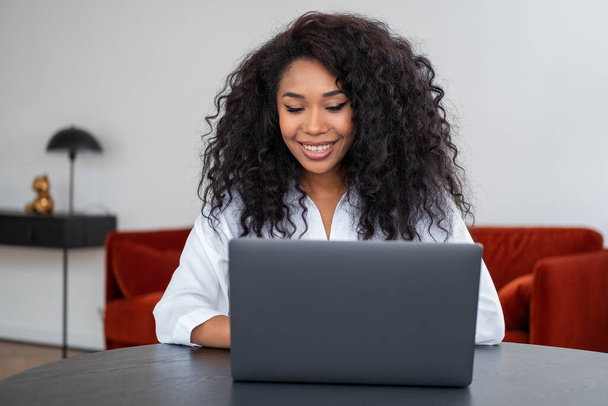 Smiling african businesswoman with laptop, online video conference. Web connection and distance work. Concept of communication - Fotoğraf, Görsel