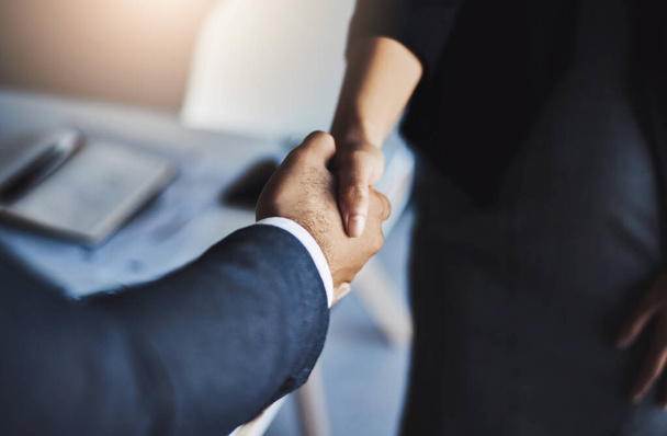 Joining forces to become the best at business. Closeup shot of two unrecognizable businesspeople shaking hands in an office - Photo, Image