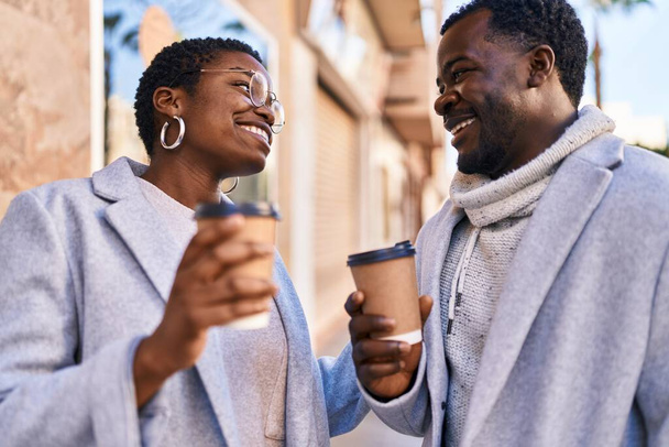 Man and woman couple standing together drinking coffee at street - Foto, immagini