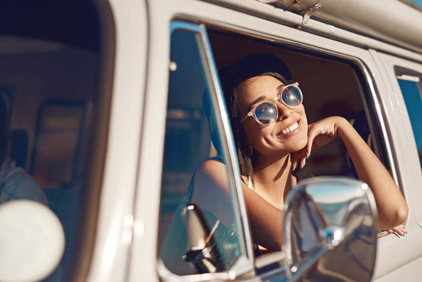 This summer out summers the last one. a happy young woman daydreaming on a road trip - Photo, Image