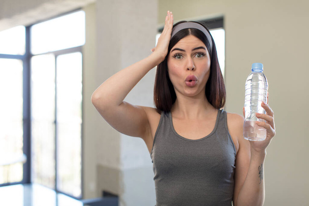 pretty young woman feeling extremely shocked and surprised. water bottle concept - Foto, immagini
