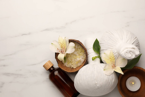 Flat lay composition with spa products and flowers on white marble table. Space for text - Fotografie, Obrázek
