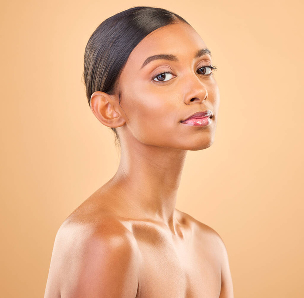 Beauty portrait, face and a woman in studio for skincare, cosmetics, dermatology or makeup. Aesthetic female for self care, natural skin and spa facial shine or wellness results on a brown background. - Foto, imagen