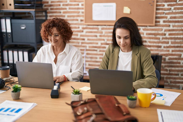 Two women business workers using laptop working at office - Zdjęcie, obraz