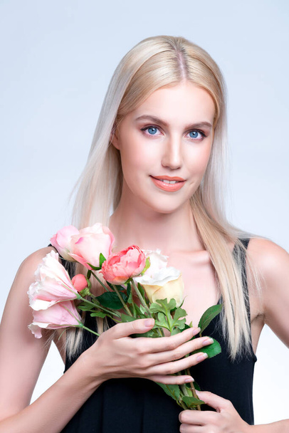 Closeup young personable woman with natural makeup and healthy soft skin holding rose for beauty care advertising in isolated background. Beautiful pretty model girl with flower concept. - Fotografie, Obrázek