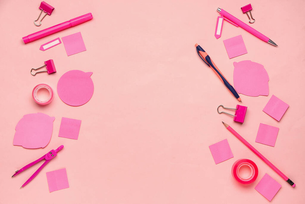 Moldura feita de canetas, notas pegajosas e clipes de papel sobre fundo rosa - Foto, Imagem