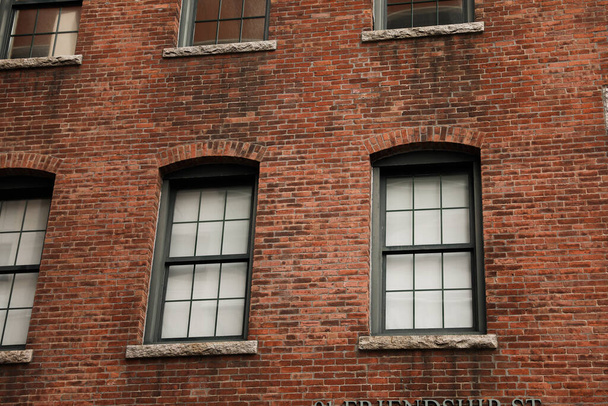 brick wall with windows and a window - Foto, Imagen