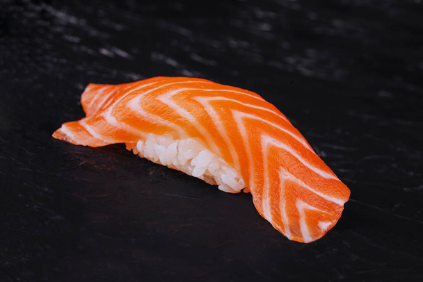Salmon nigiri sushi on black stone - Photo, Image