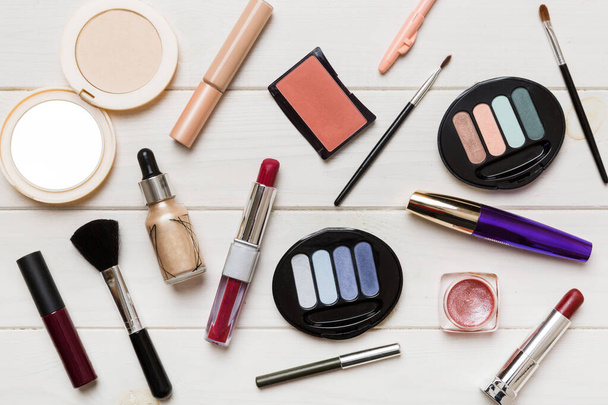 Professional makeup tools. Top view. Flat lay. Beauty, decorative cosmetics. Makeup brushes set and color eyeshadow palette on table background. Minimalistic style. - 写真・画像