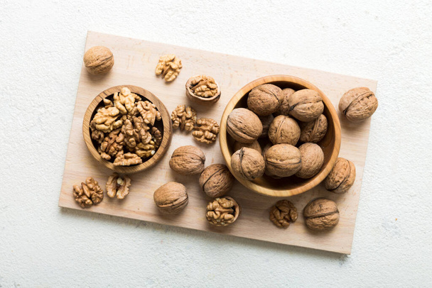 Fresh healthy walnuts in bowl on colored table background. Top view Healthy eating bertholletia concept. Super foods. - Photo, Image