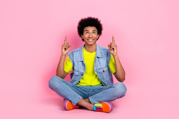 Full length photo of positive glad attractive man wear stylish bright clothes arm demonstrate empty space isolated on pink color background. - Photo, Image