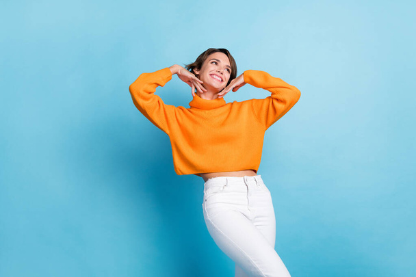 Photo of pretty young girl hands frame face beauty spa salon cosmetologist dressed stylish orange outfit isolated on blue color background. - 写真・画像