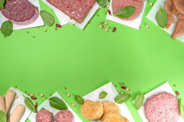 Lab-grown or plant based red meat steaks over green background - Φωτογραφία, εικόνα